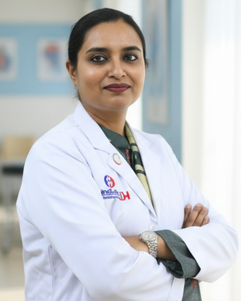 Dr. Shabnam Rahman, Ex-Major and Consultant Gynecologist, standing with folded arms in a modern hospital corridor, representing her dedication, compassion, and journey in women's healthcare.